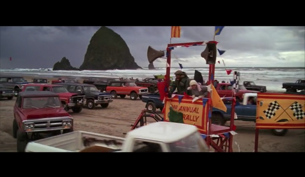 Truck rally scene from The Goonies with Haystack Rock in the background