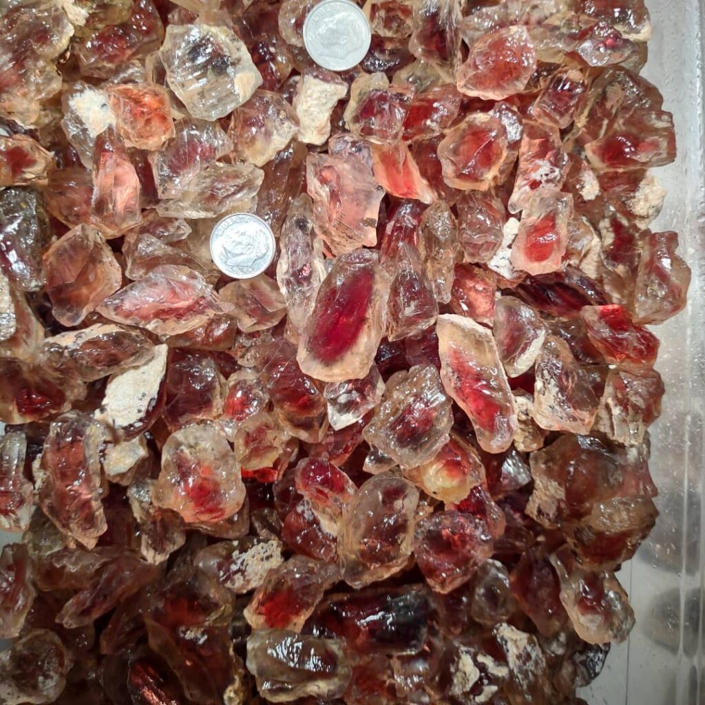 A box of red sunstones that are the size of a dime or larger. They're very pretty.