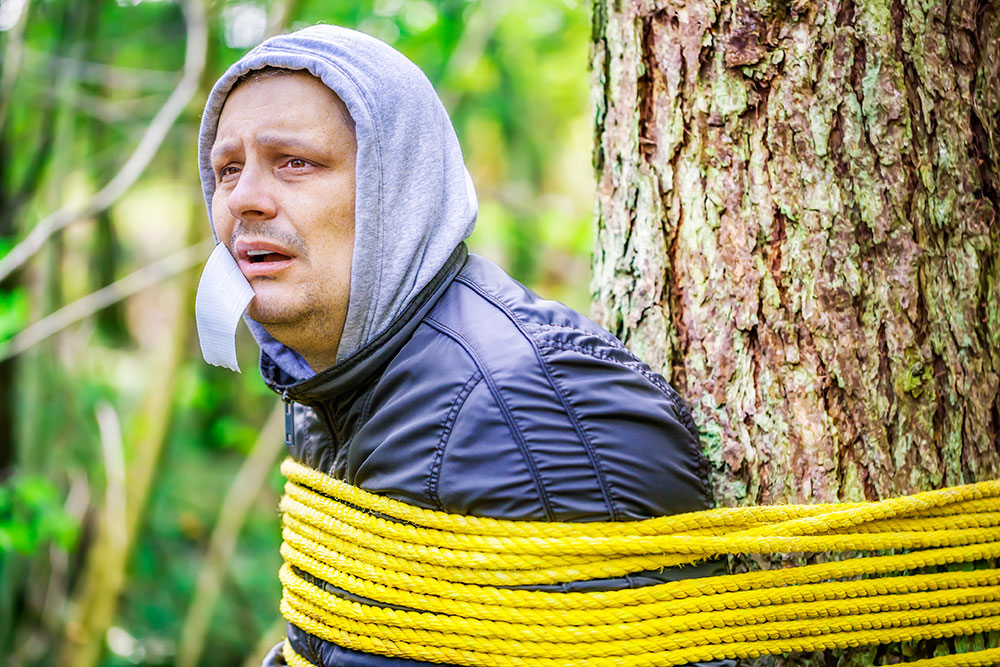man-tied-to-tree