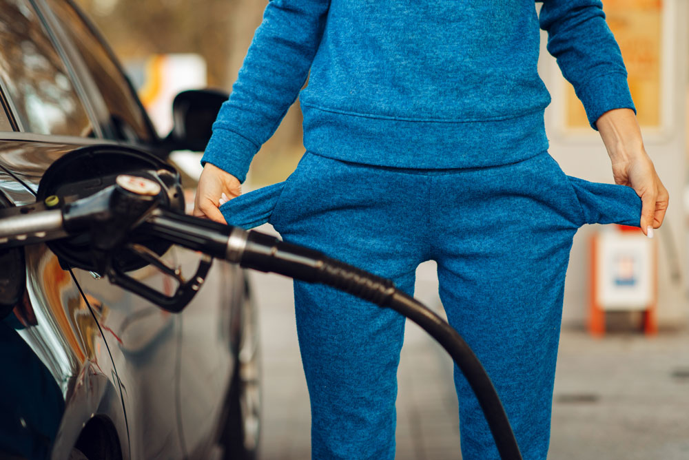 female-person-with-empty-pockets-on-gas-station-2021-08-27-09-40-34-utc Broke at the gas pump