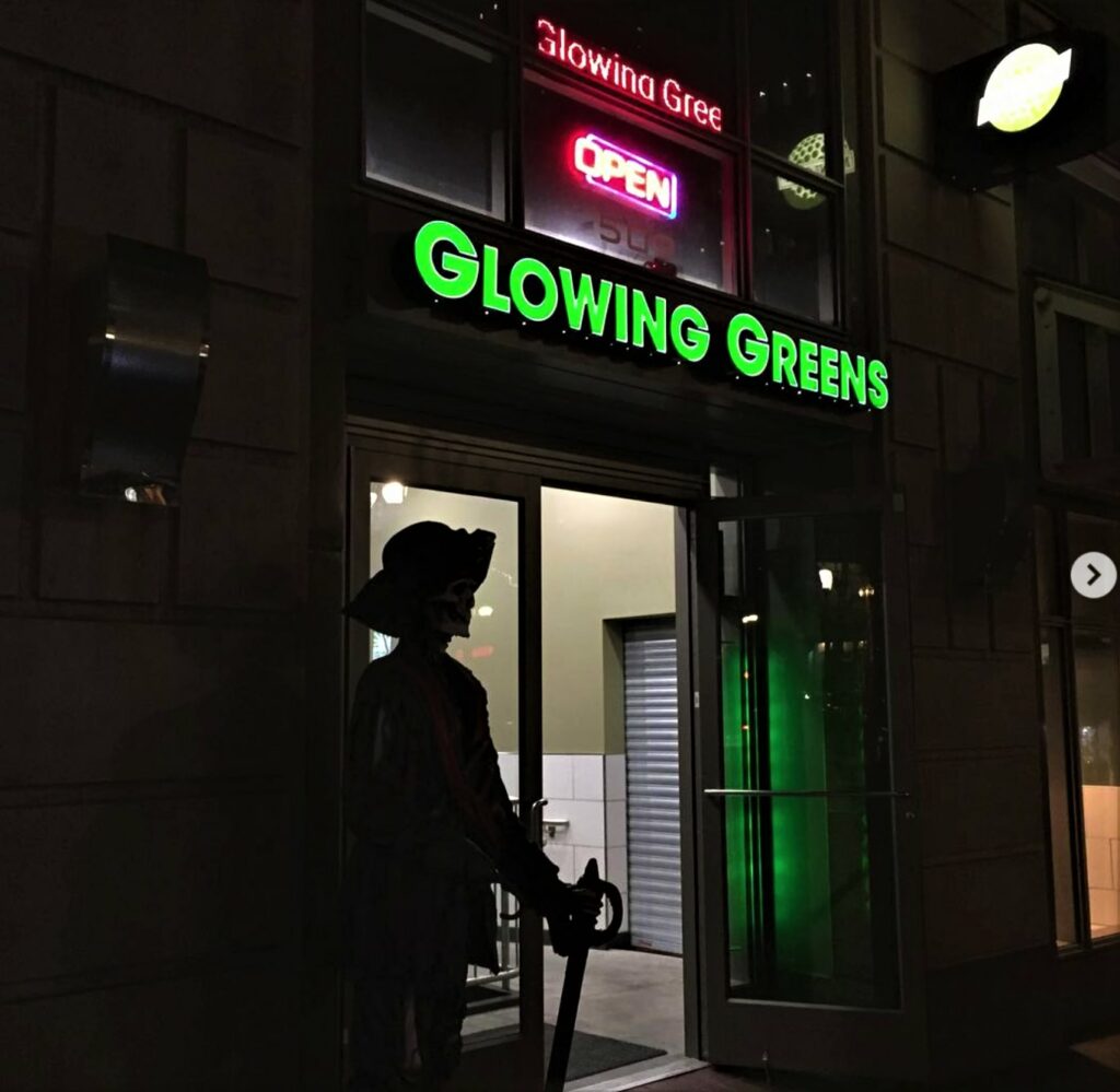 Glowing Greens building exterior at night
