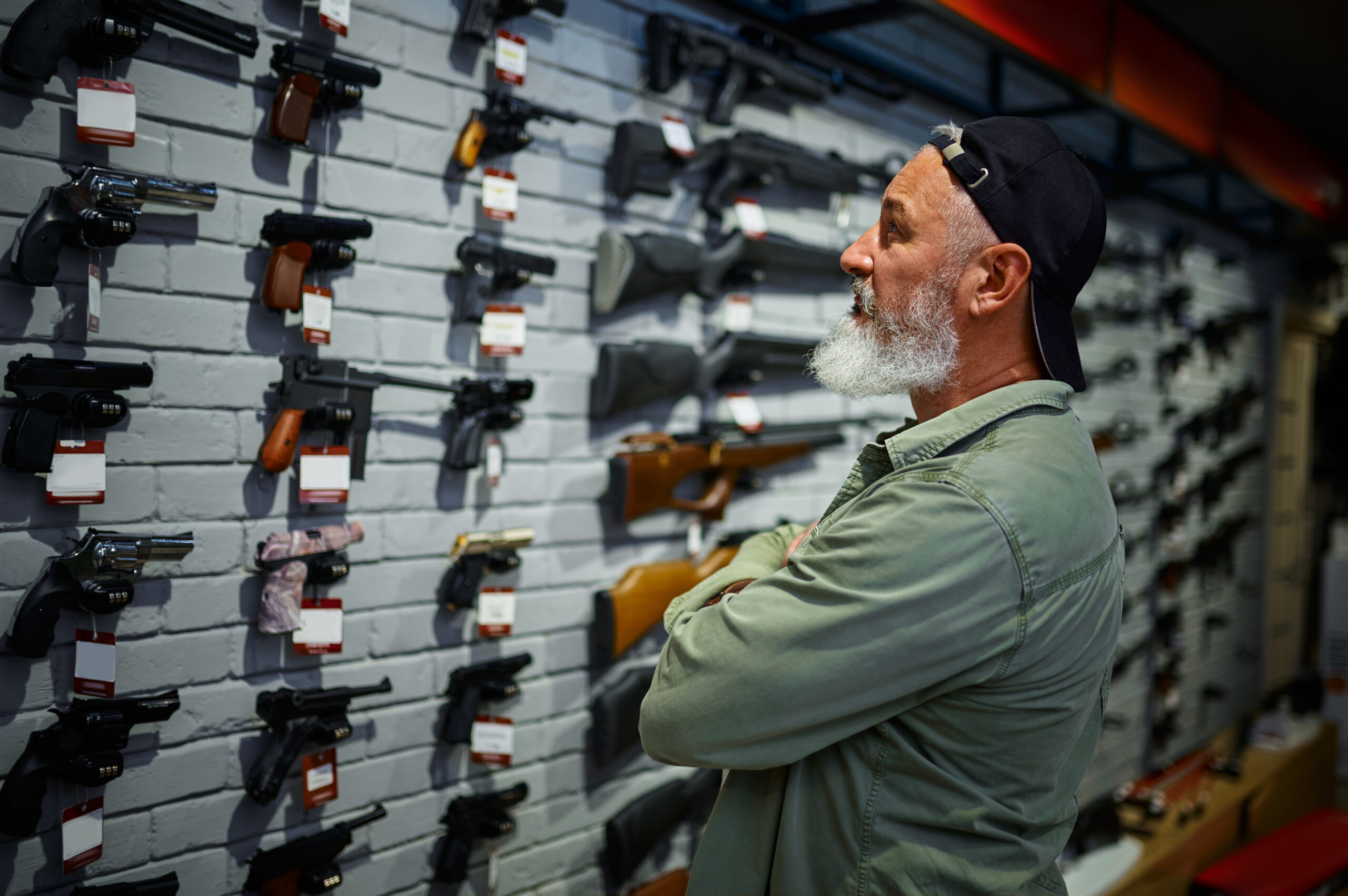 ENV Gun store, firearm store. Oregon gun control laws, 2022, 2023 A man looking at guns at a firearm store. Oregon gun control laws 2022, 2023.