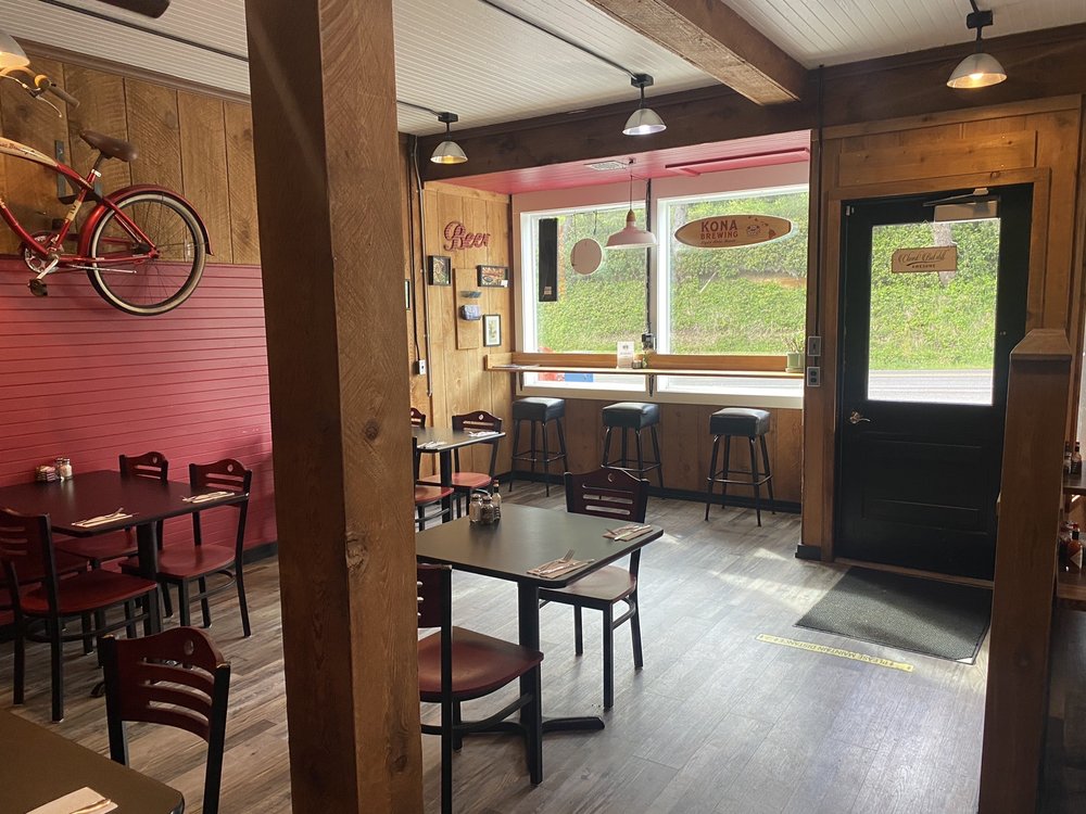 The cozy interior of Hilltop Cafe Bistro. Warm wood tones, lots of light, and an almost cowboy vibe.