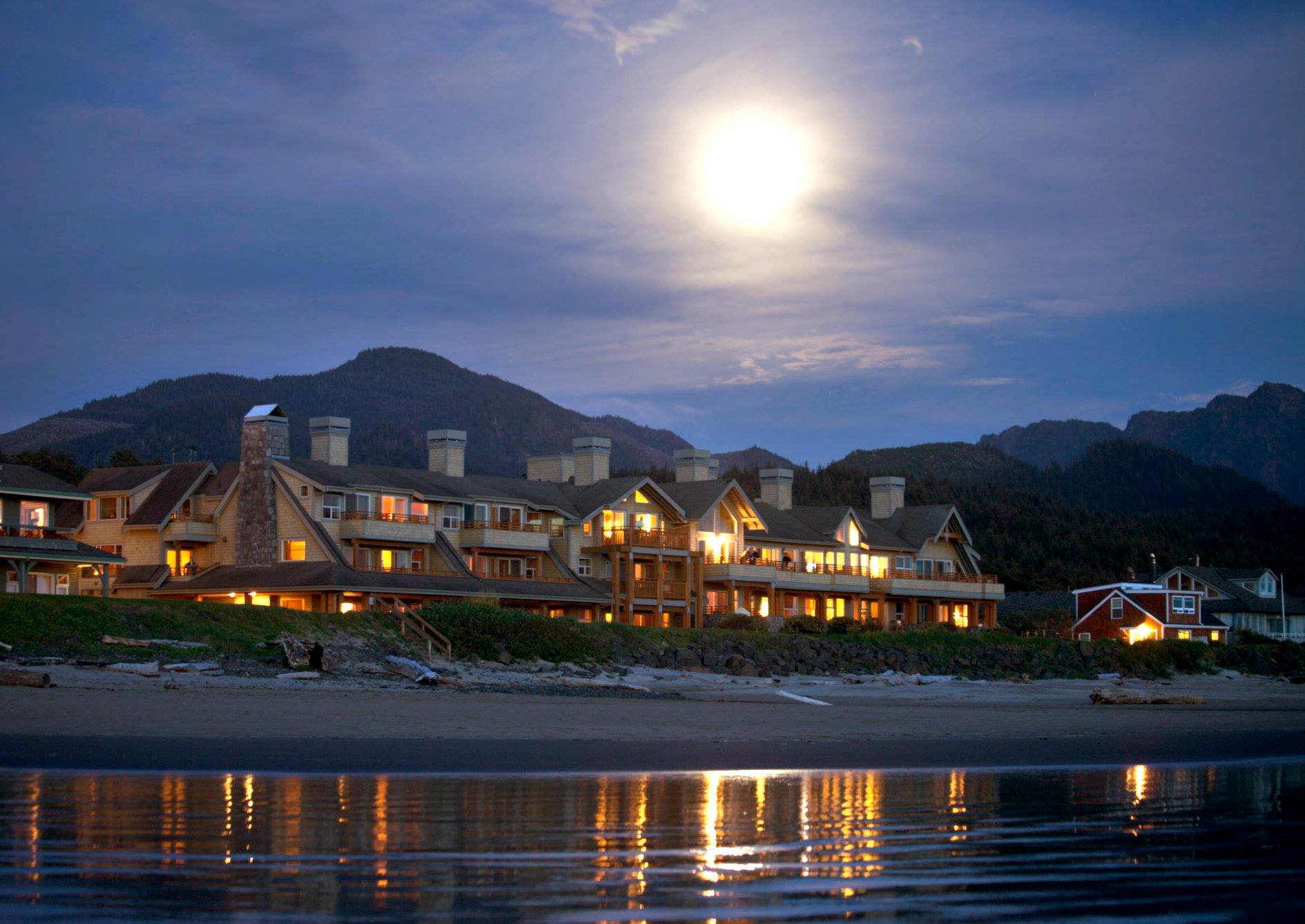 The Ocean Lodge via Facebook The Ocean Lodge exterior at night lit by the moon as seen from the beach.
