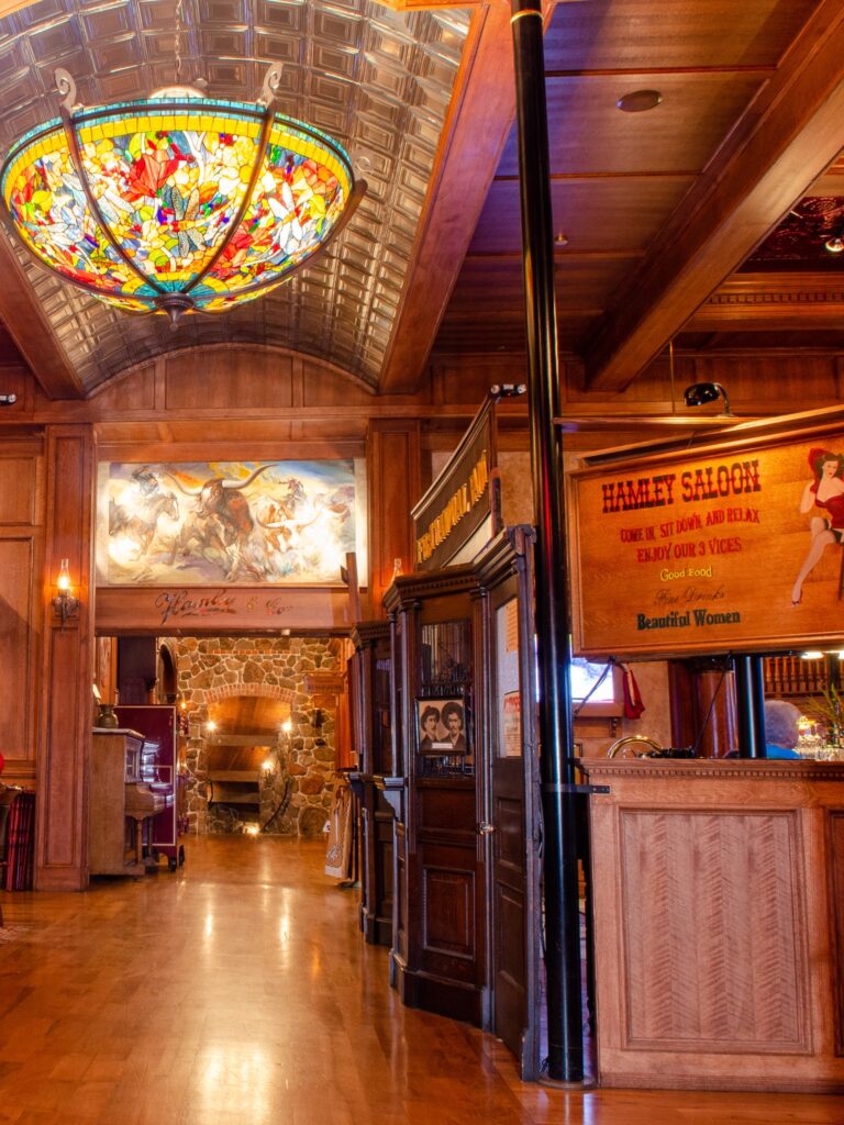 The interior of Hamley Saloon. The walls, floors and ceiling are all rich warm wood.