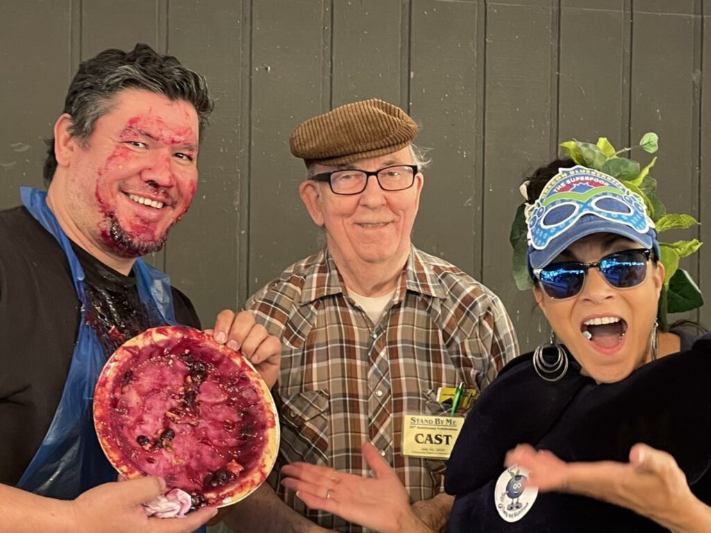 A man covered in blueberry pie after a pie eating contest at Stand By Me Day.