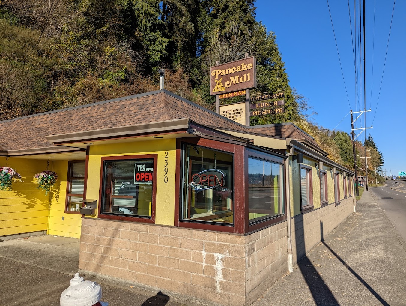 The Pancake Mill in North Bend, Oregon. Photo by Mark Botelho via Google Local. The outside of The Pancake Mill in North Bend, Oregon. The building is yellow, with brown trim and a brown roof. The sign is brown with yellow lettering.