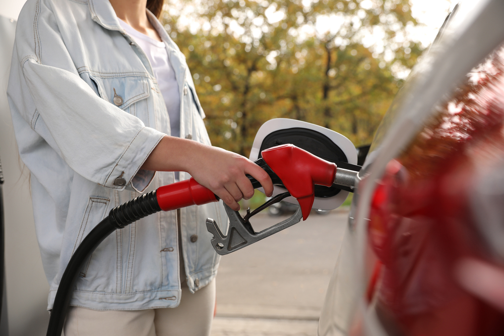 Woman,Refueling,Car,At,Self,Service,Gas,Station,,Closeup pumping gas oregon