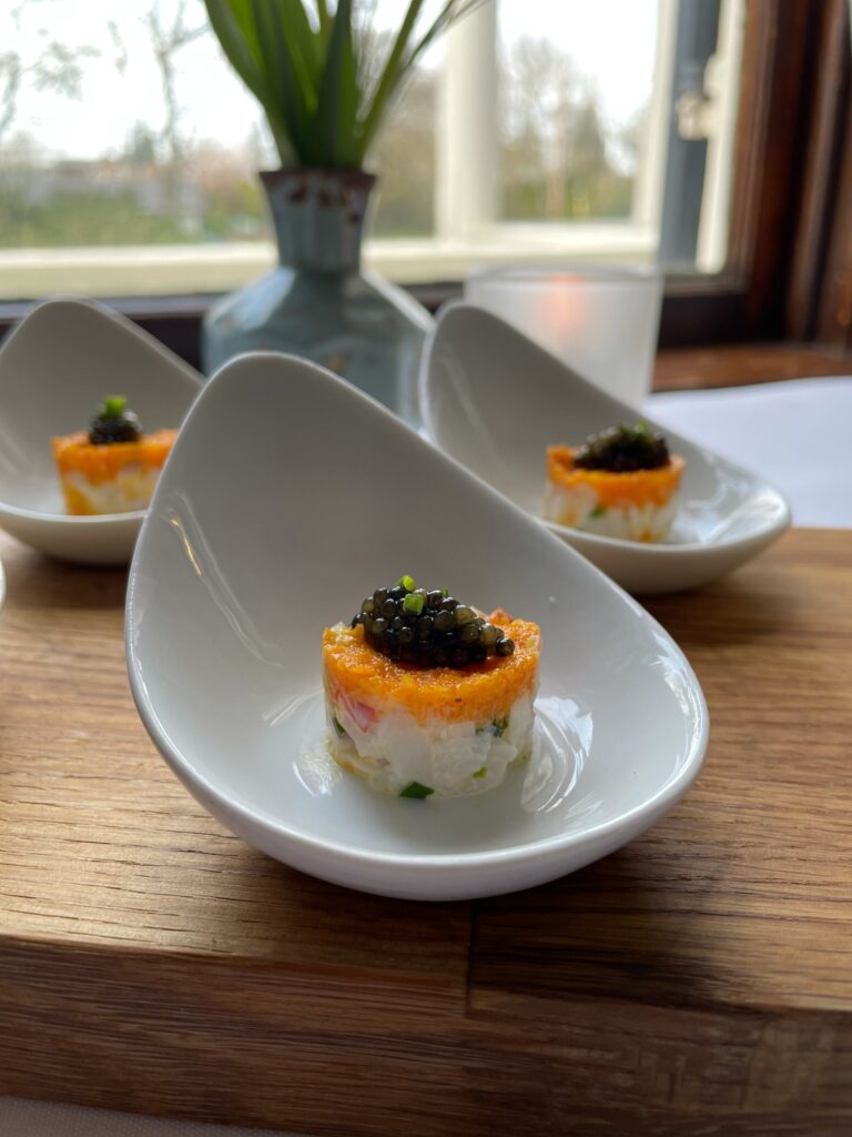 Food on a fancy white dish.