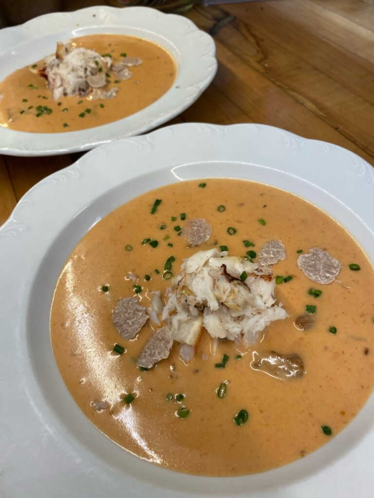 A large white bowl with soup.