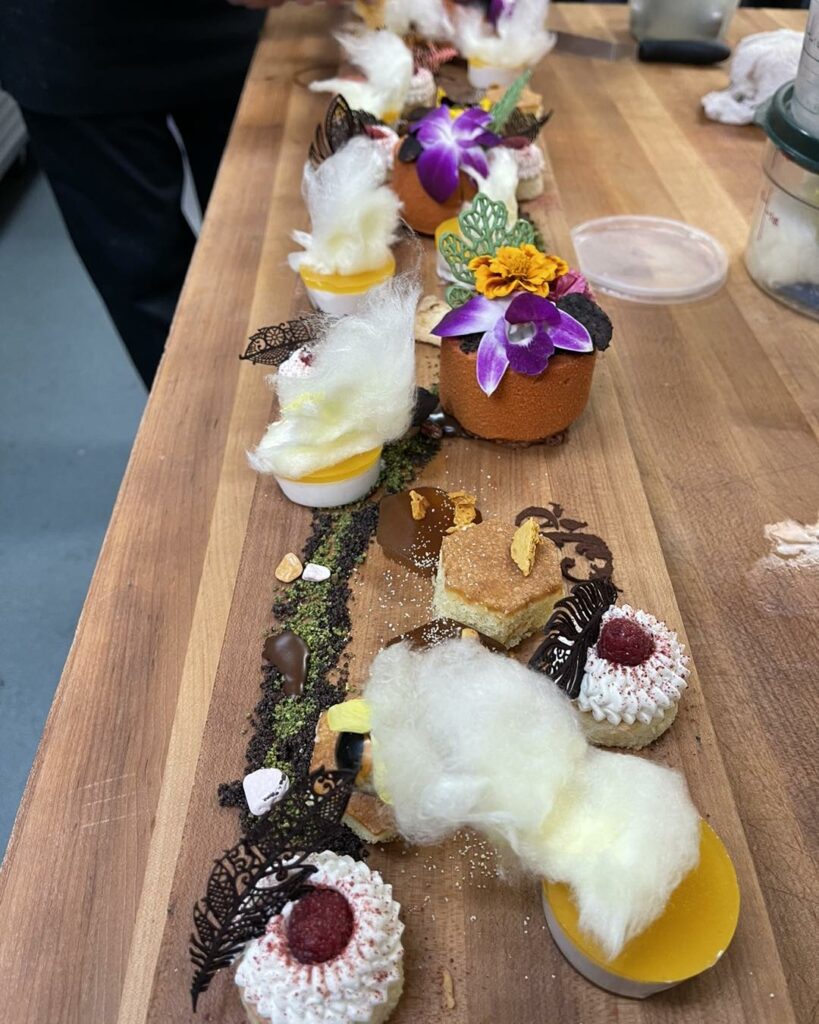 Food lined up on a wooden cutting board.