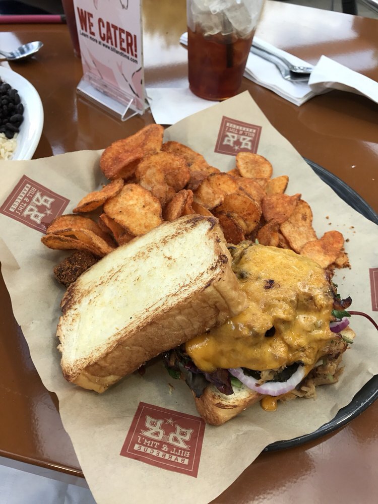 A huge cheeseburger with barbecue chips.