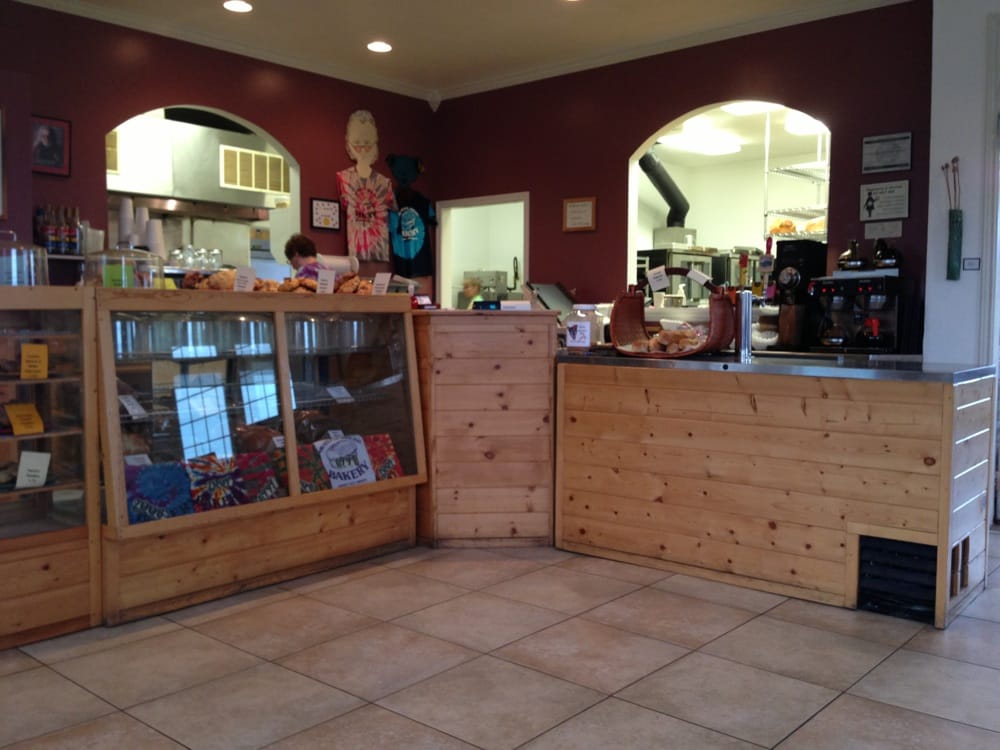 A wooden counter with a dark red wall.