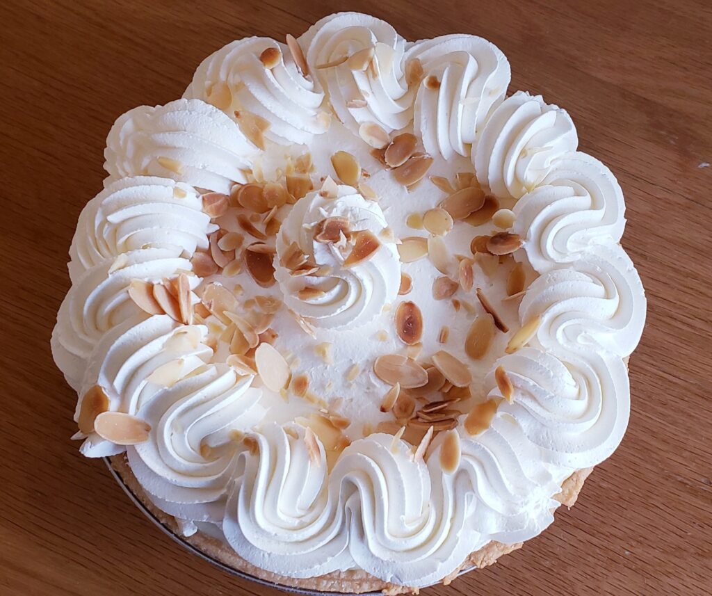 Banning's Restaurant, Tigard Oregon, Good Eats, Comfort Food, Best Places To Eat, Famous Pie House, Old School Diners, Portland Area, Where to Eat in Tigard, A whole pie with white whip or frosting on top and sliced nuts sprinkled on top.
