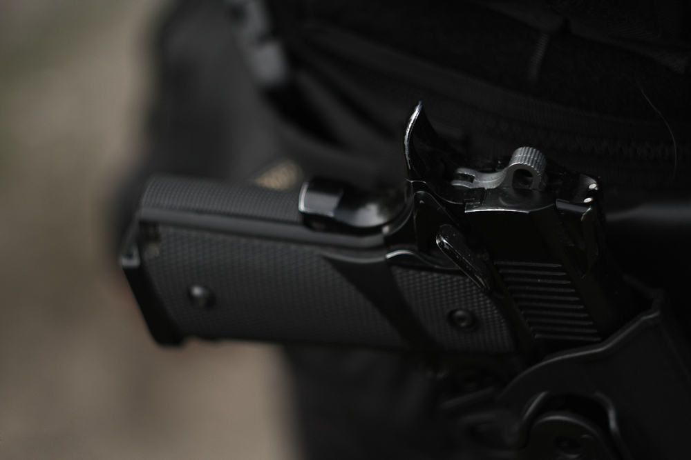 Black,Gun,In,A,Holster,On,The,Belt,Of,A holstered firearm