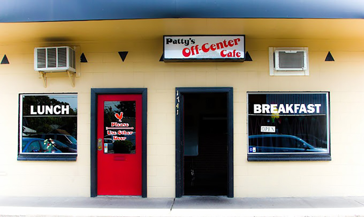 AF1QipMannATcAReEygvYNqdhL_l6soz The exterior of Patty's Off Center Cafe in Salem, Oregon. It's a brick building with red doors and black trim.
