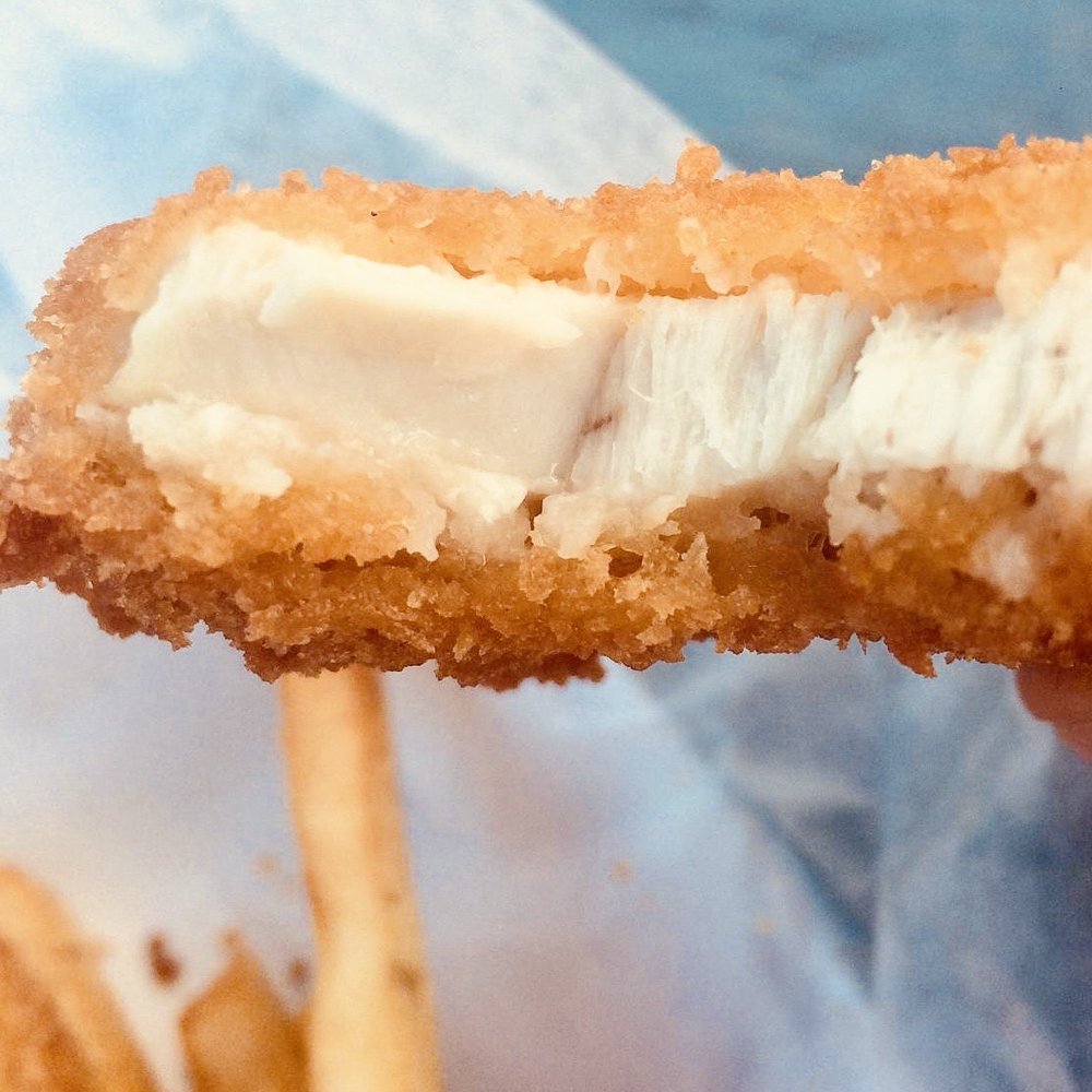 A big piece of flaky tuna. It's white in the center and has a panko-like crust all the way around the edges.