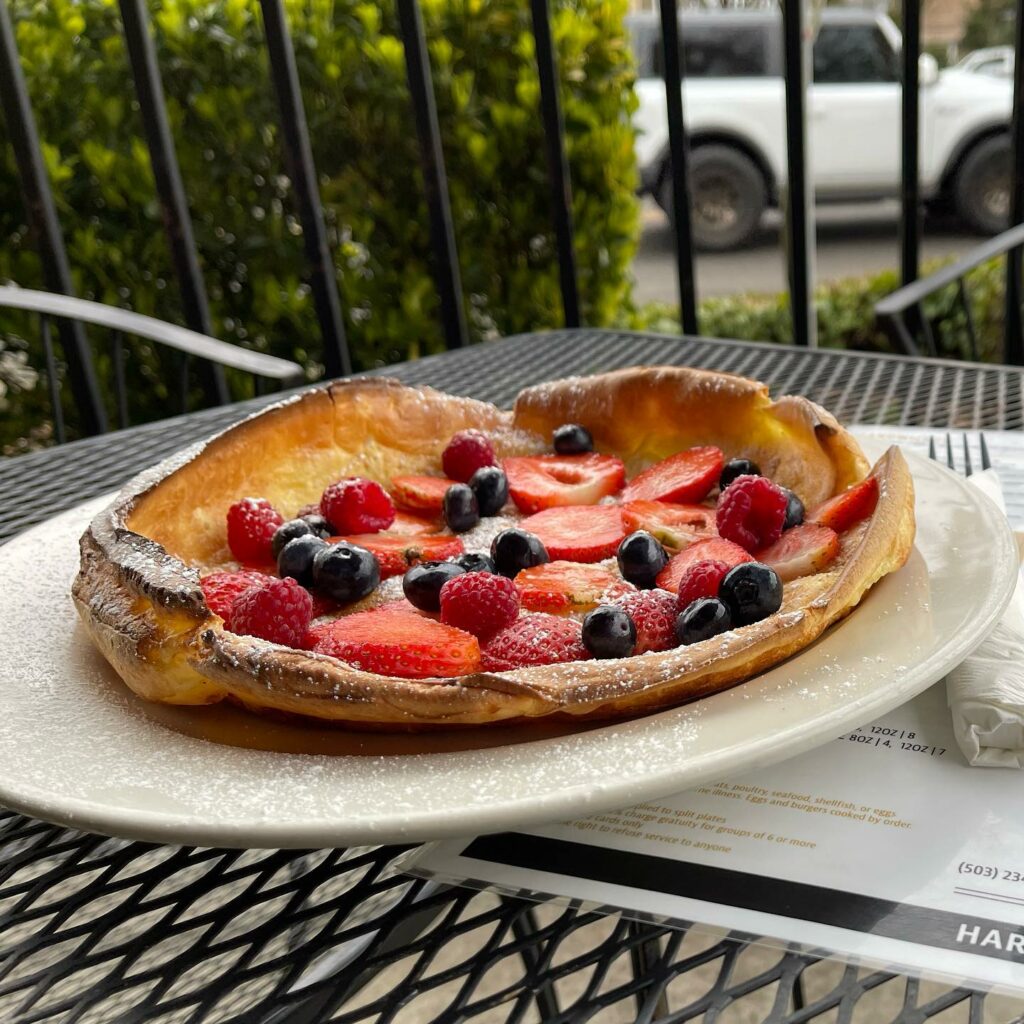A waffle with blueberries and strawberries.