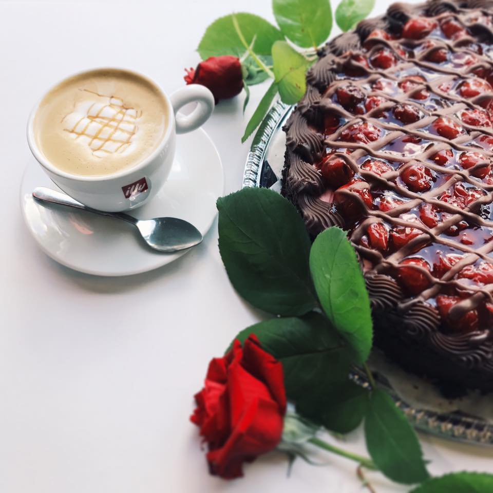 Black Forest Mousse Torte beside a caramel macchiato. It looks so delicious!