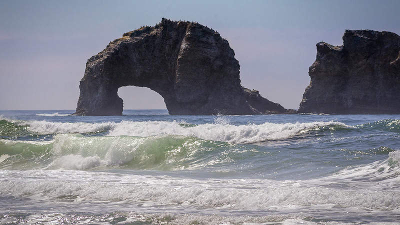 Twin Rocks. It's a huge arched rock in the ocean surf.