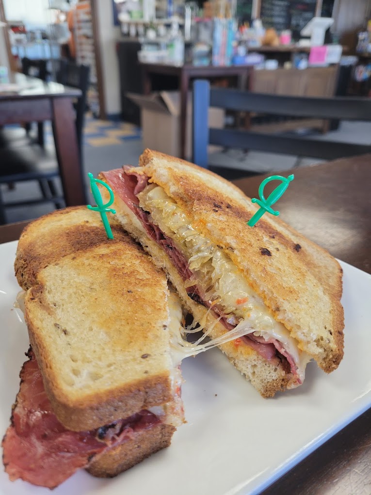 A hot sandwich with meat and cheese.