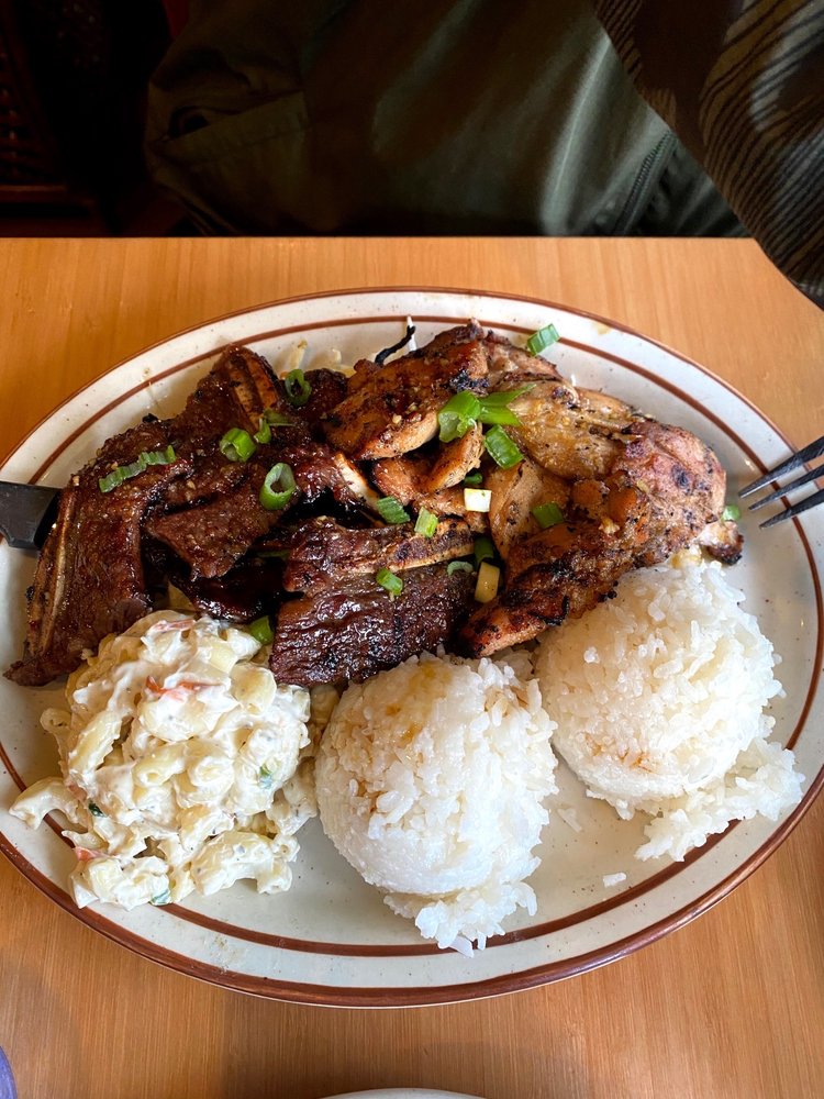 A plate with mac salad, sticky rice and marinated meat with chopped green onion on top.