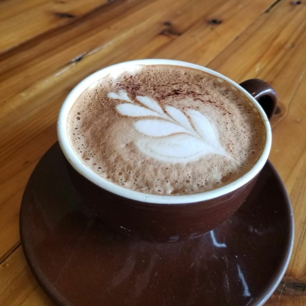 Coffee with a foam design on top.