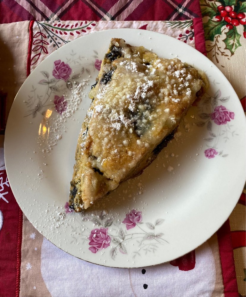 A blueberry scone with lemon glaze.