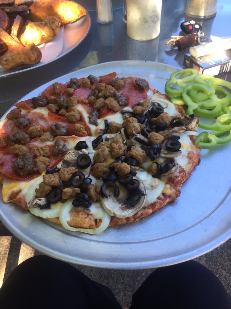 A delicious looking pizza with lots of toppings.