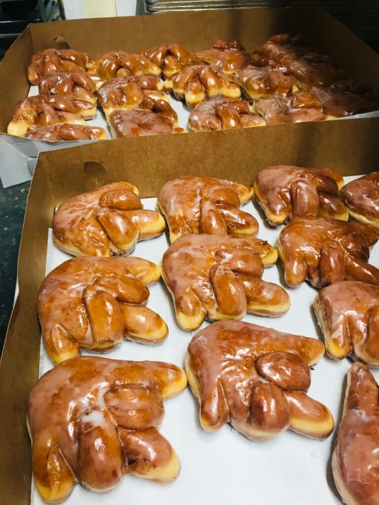 A box of middle finger shaped donuts.