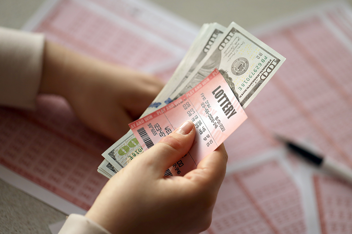 A,Young,Woman,Holds,The,Lottery,Ticket,With,Complete,Row lottery ticket