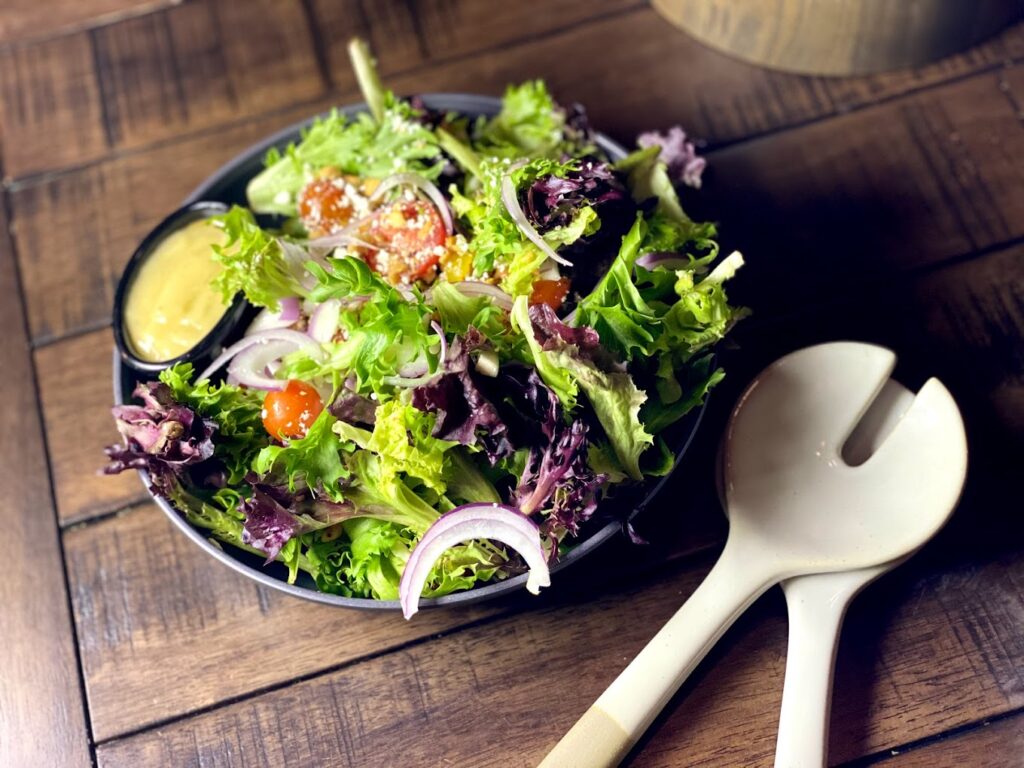 A really tasty looking salad with fresh ingredients and brightly colored lettuce in tones of green and purple.