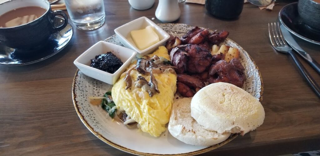 A tasty looking plate of breakfast food featuring eggs and other breakfast items. It's plated really well. This is fine dining, not your typical restaurant breakfast fare.