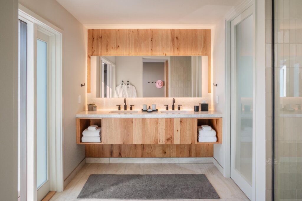 The interior of one of the bungalows. There are soft wood tones on the floors, walls, ceiling, and furniture.