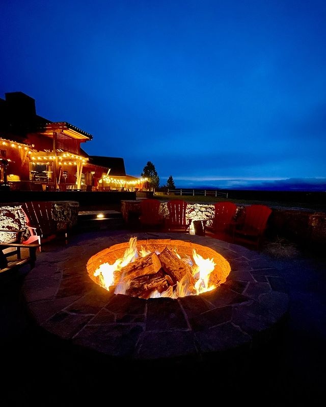 A firepit at Brasada Ranch after dark. The fire pit is lit and ready to toast marshmallows.