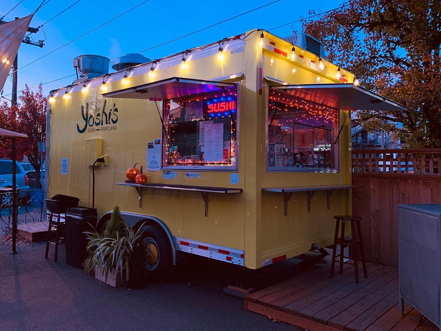 Photo via Yoshi’s Sushi Facebook page. The Yoshi's Sushi food truck lit up at night.