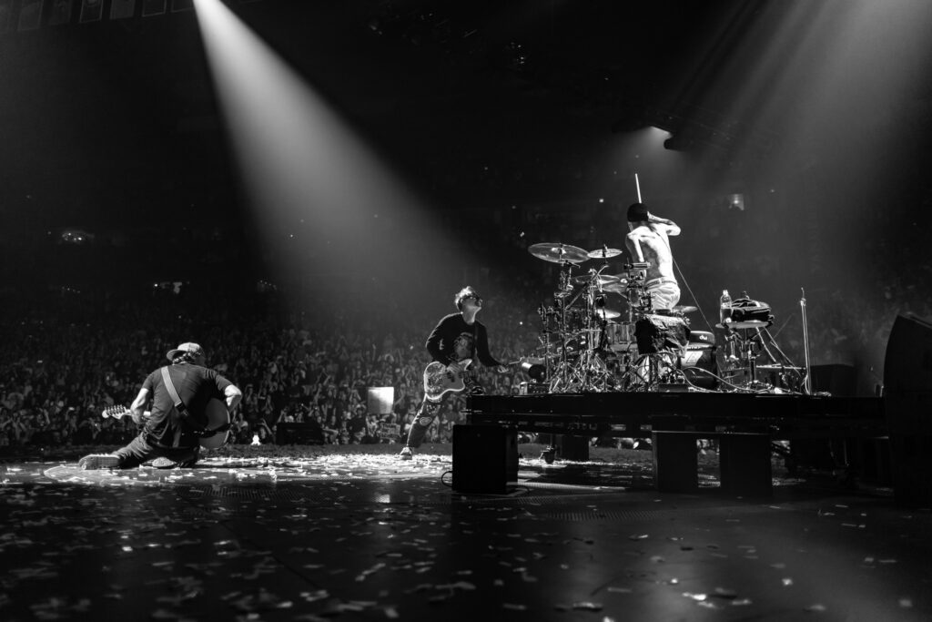 A black and white photo of Blink-182 performing on stage. Summer concerts, Oregon, Things to do, 2024