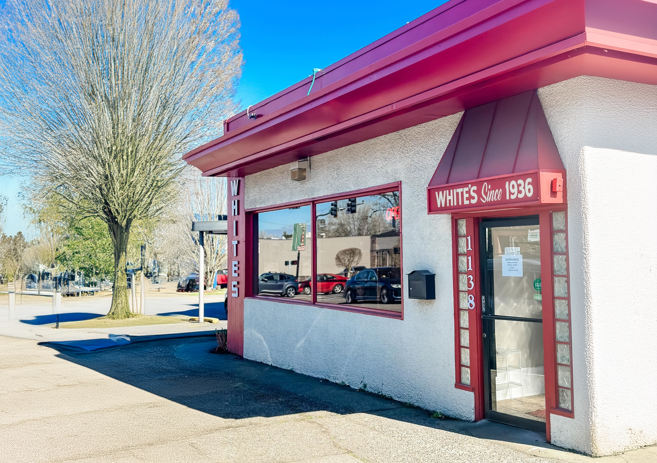 Photo via the White’s Restaurant Facebook page. The outside of White's Restaurant. It's a white building with a red roof and red trim.