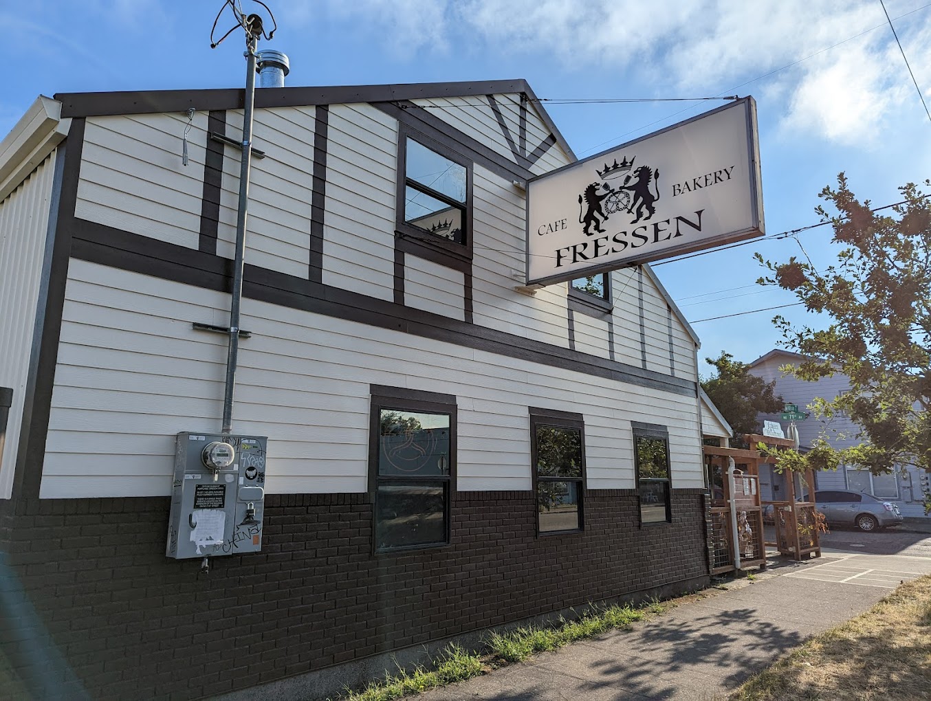 Photo by Weston Ruter via Google Local. The outside of Fressen Artisan Bakery in Portland, Oregon. It's a white building with brown trim and accents.