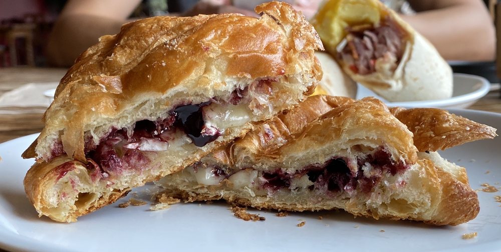 A delicious looking black and Brie croissant.