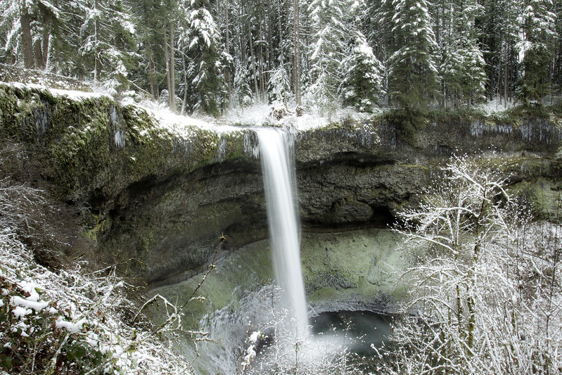 Ice and snow at Silver Falls State Park. Photo by Bonnie Moreland via Flickr CC2. Ice and snow at Silver Falls State Park. A waterfall cascades down into a pool below.