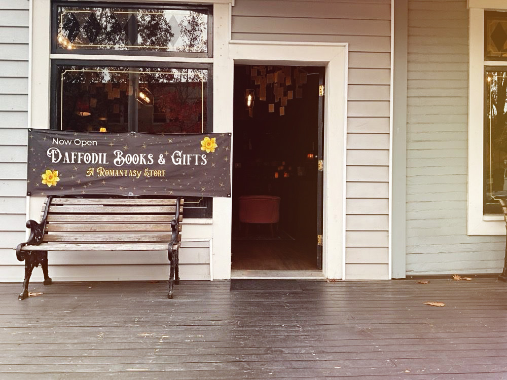 Daffodil Romantasy Book Store in Eugene, Oregon. Photo by Quentin T. via Yelp. The outside of Daffodil Romantasy Books in Eugene, Oregon. It's a building with white siding. In this photo, there's a bench out front, and the door is open. You can see a chandelier with book pages hanging down from it inside.