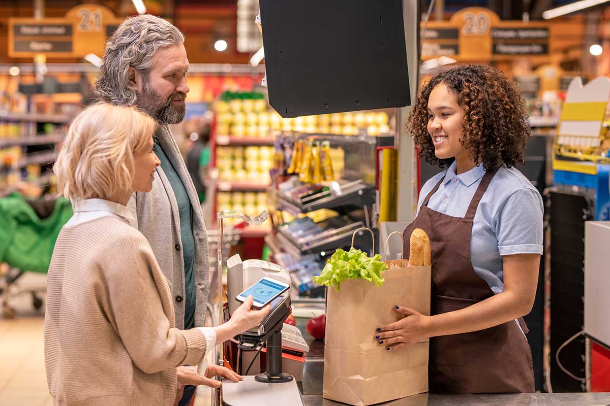 shutterstock_1694358535 happy people grocery store