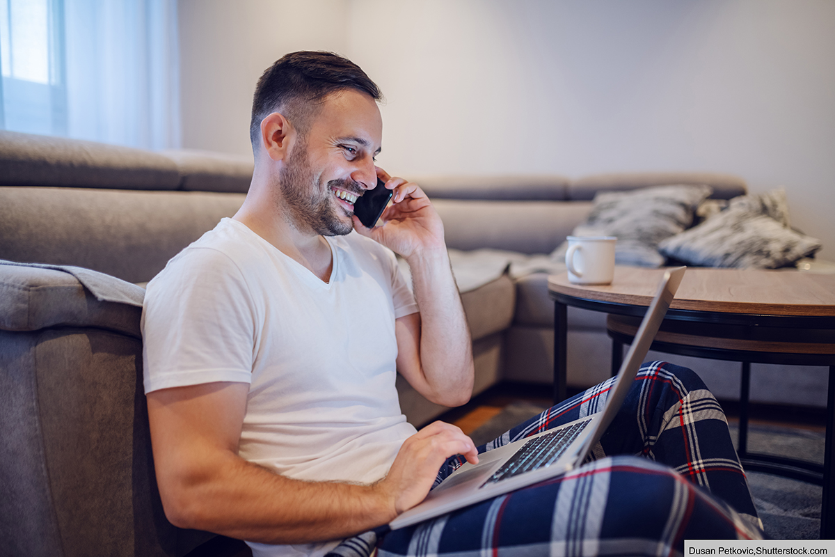 Happy,Caucasian,Businessman,In,Pajamas,Sitting,On,The,Floor,In stay at home boss