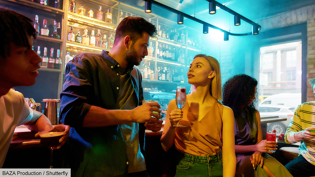 Making,Night,Memorable.,Young,Man,Leaning,On,Bar,Counter,,Drinking flirting with girl at a bar