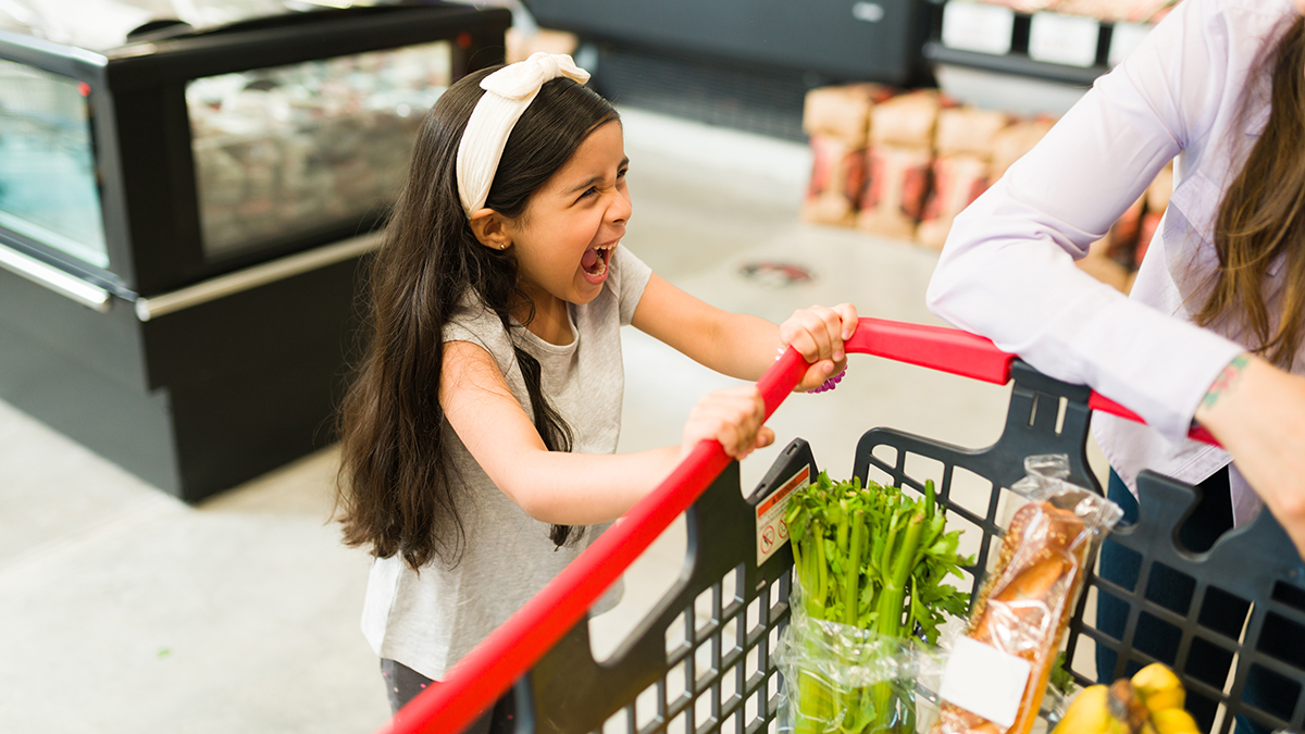 Angry,Little,Kid,Screaming,And,Throwing,A,Tantrum,While,Grocery screaming child