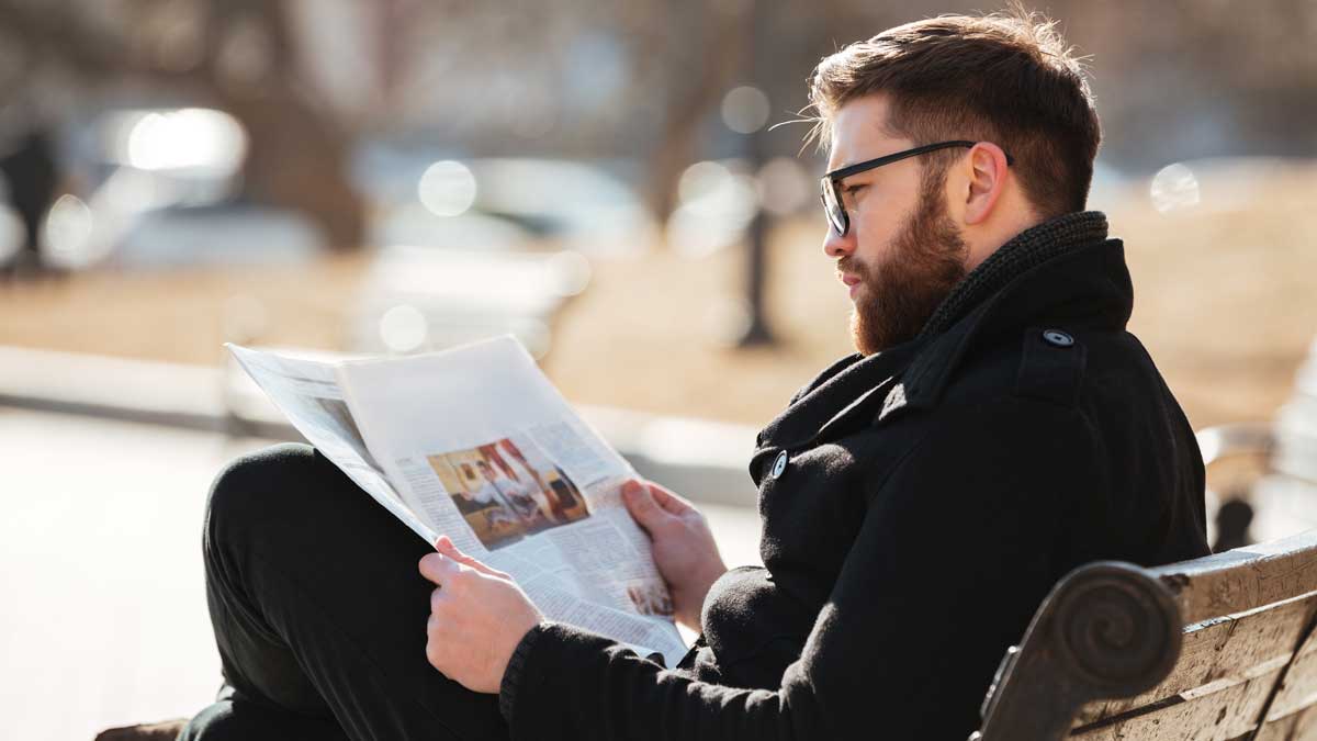 man_reads_paper Man reading a newspaper in Portland