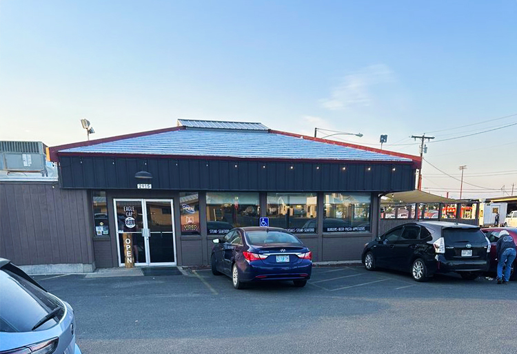 Photo by Lisa B. via Yelp. The outside of Eagle Cap Grill. It's a gray restaurant with a gray roof.
