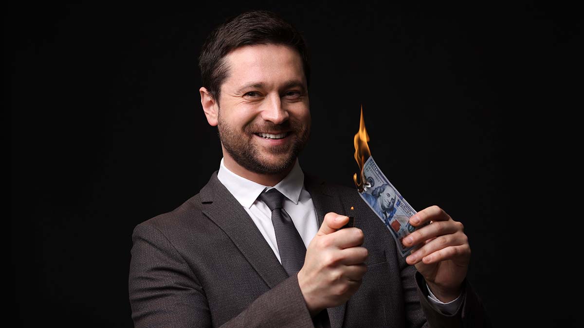 Greedy,Businessman,Burning,Dollar,Banknote,With,Lighter,On,Black,Background state audit oregon