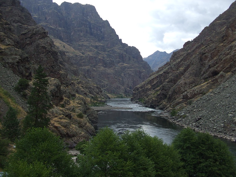 A view from inside Hells Canyon. Photo by Haydn Blackey via Flickr CC2. A view of the towering cliffs around the river inside Hell's Canyon.